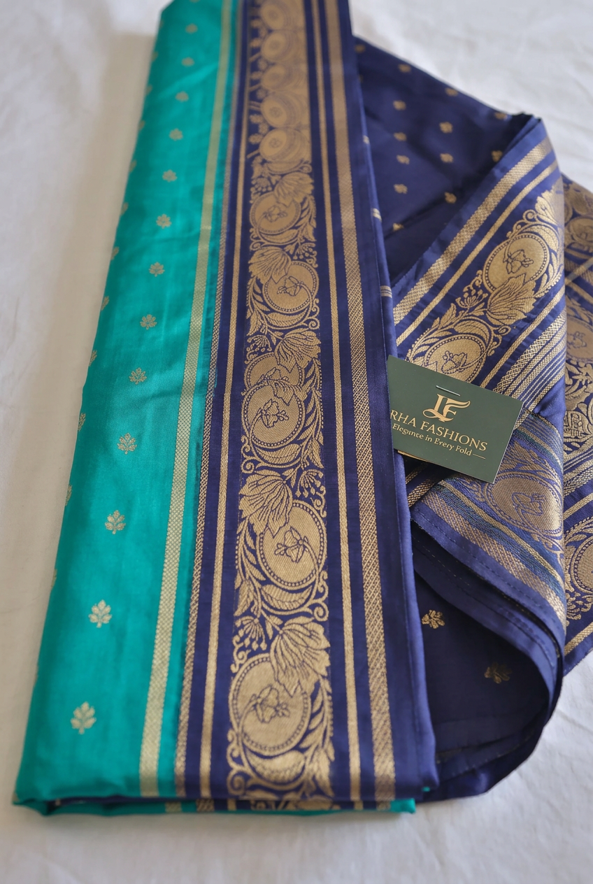 Side angle of the teal saree showing the navy blue zari border and pallu edge